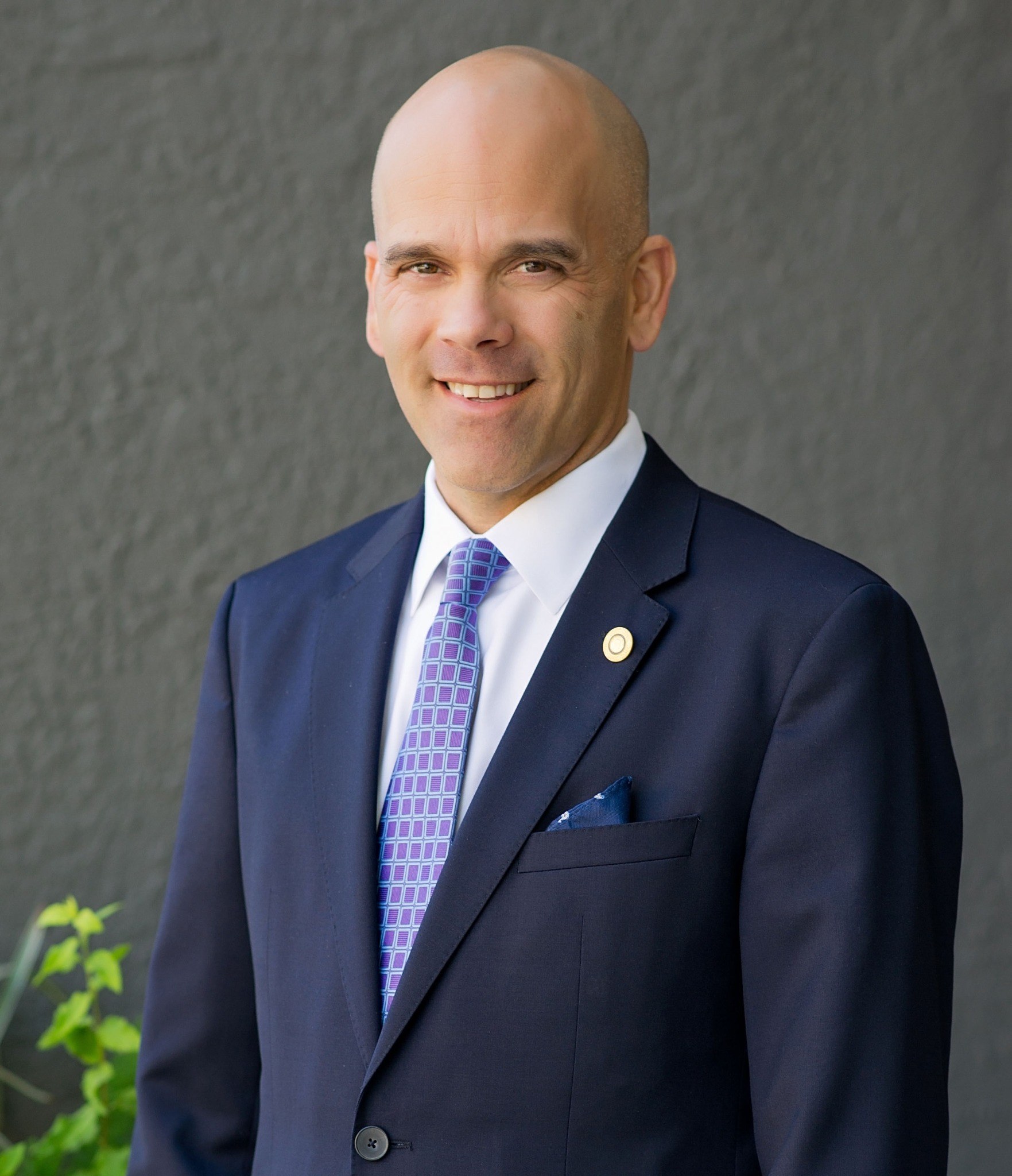 Professional portrait of John during his legal career